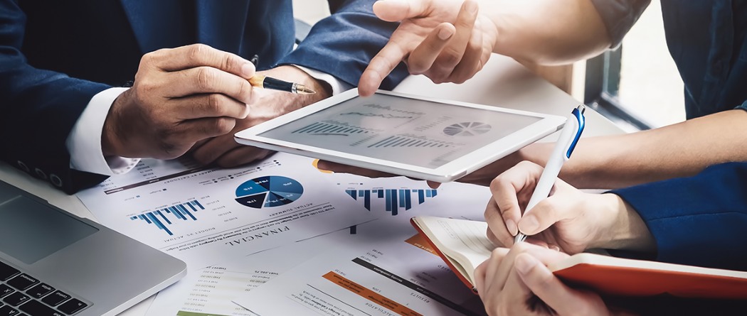 financial investors discussing graph and pie charts