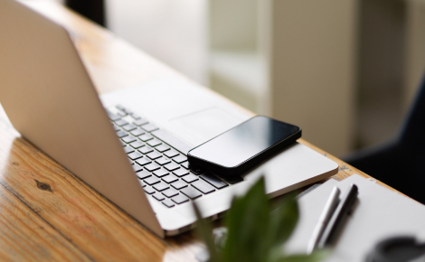 Desk with laptop and mobile phone