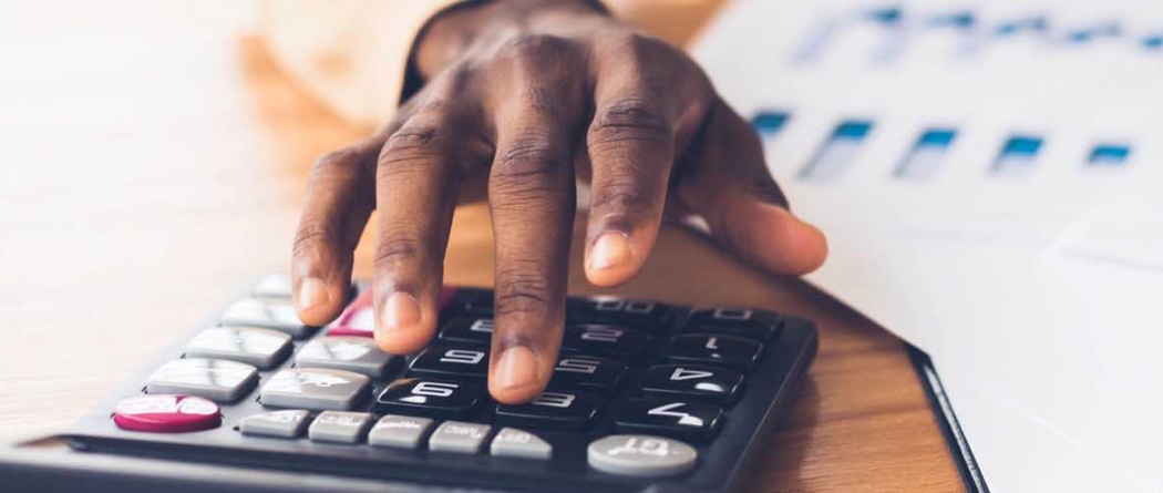 a hand working on a calculator