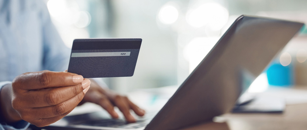 a person holding a credit/debit card