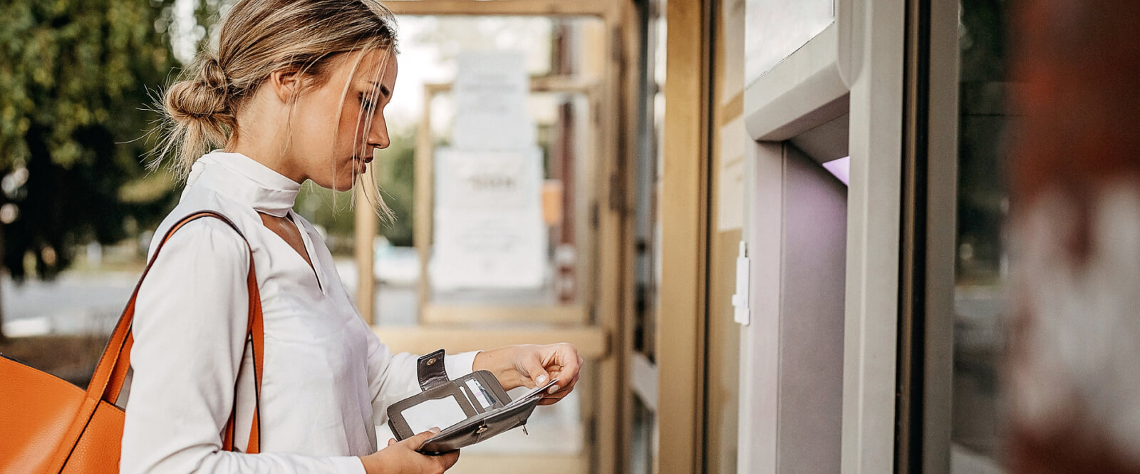 woman using card at ATM